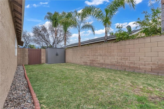 view of yard with an outbuilding, a shed, and a fenced backyard