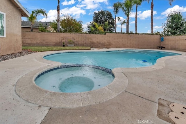 view of swimming pool with a pool with connected hot tub and a fenced backyard