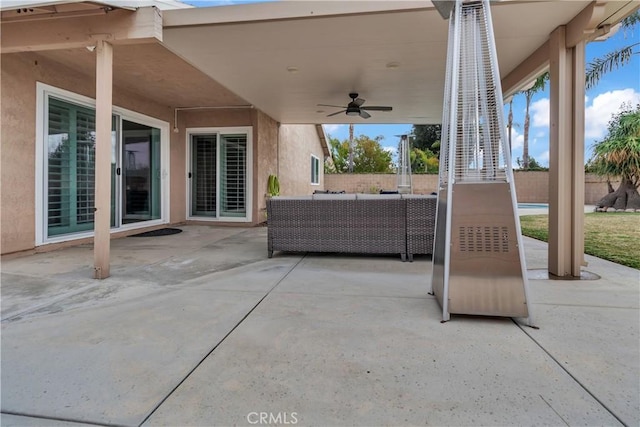 view of patio / terrace with outdoor lounge area, fence, and ceiling fan