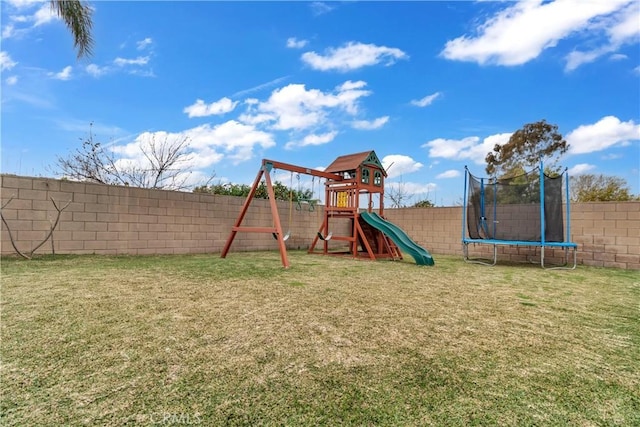 view of playground featuring a trampoline, a fenced backyard, and a lawn