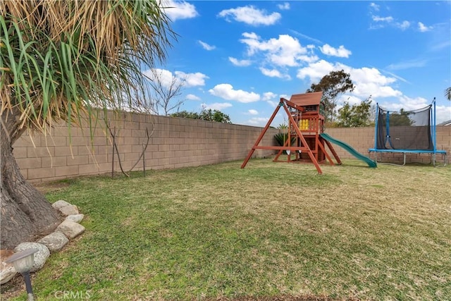 view of playground with a fenced backyard, a lawn, and a trampoline