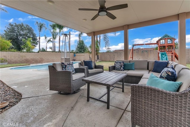 view of patio featuring a fenced in pool, a fenced backyard, ceiling fan, a playground, and an outdoor hangout area