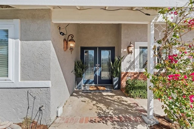 doorway to property with french doors and stucco siding