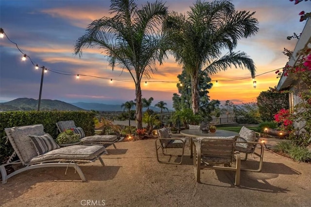 view of patio with a mountain view and outdoor dining area