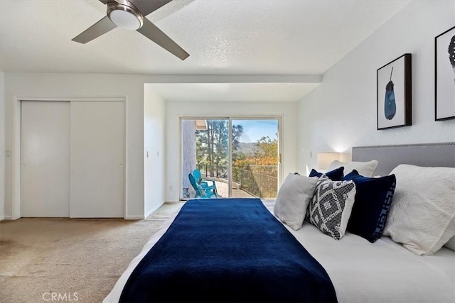 carpeted bedroom with access to exterior, a closet, a ceiling fan, a textured ceiling, and baseboards