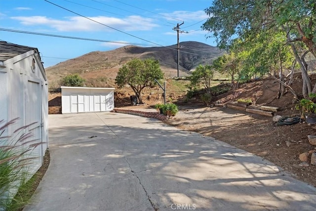 exterior space with concrete driveway and a mountain view