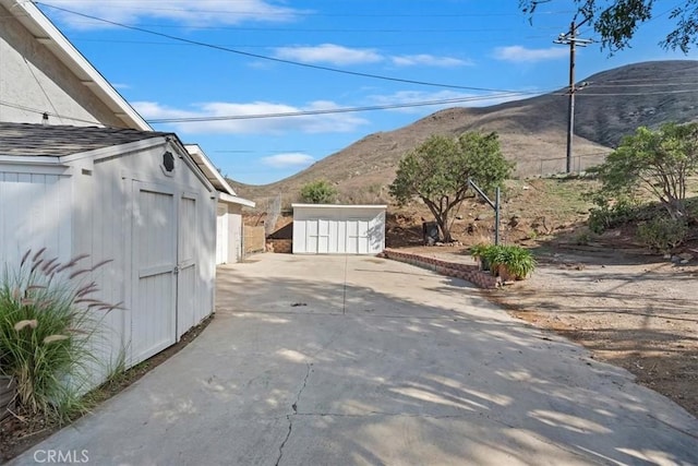 exterior space featuring concrete driveway and a mountain view