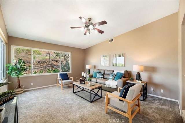 living area with carpet, visible vents, vaulted ceiling, and baseboards