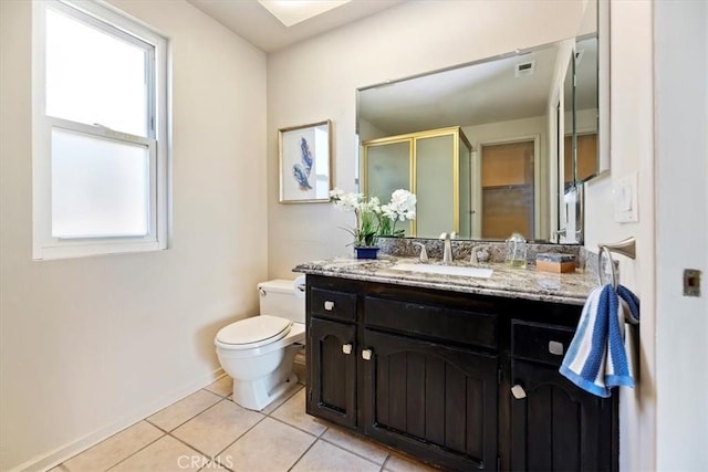 bathroom with visible vents, toilet, a stall shower, vanity, and tile patterned floors