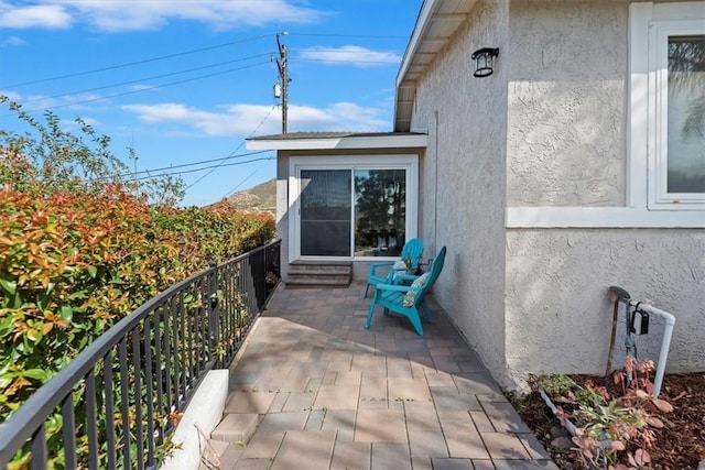 balcony featuring entry steps and a patio