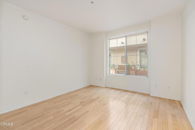 spare room featuring light wood-style flooring