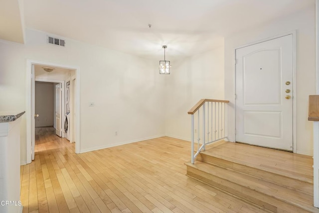 interior space featuring visible vents, light wood-type flooring, and baseboards