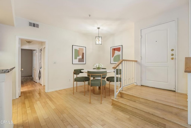 dining space featuring visible vents, baseboards, and light wood-style floors