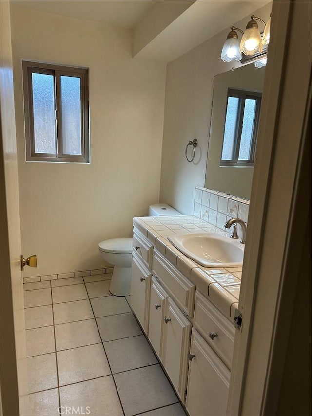 bathroom with vanity, toilet, and tile patterned floors