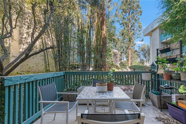 wooden deck with outdoor dining area and a patio area