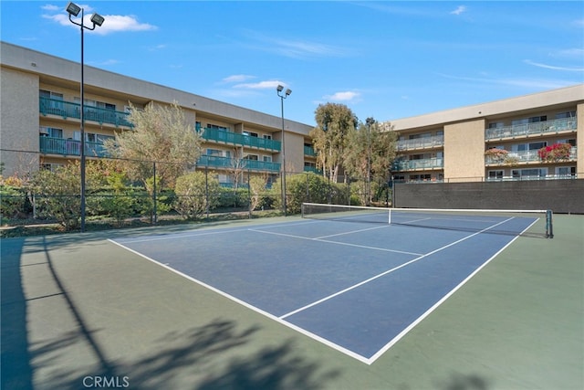 view of tennis court featuring fence