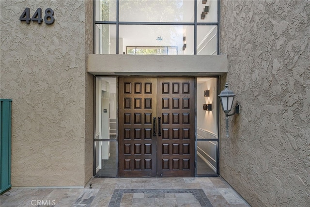 doorway to property with stucco siding