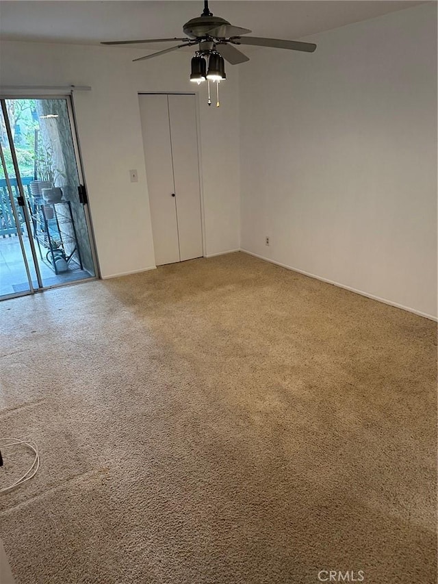 interior space featuring carpet and ceiling fan