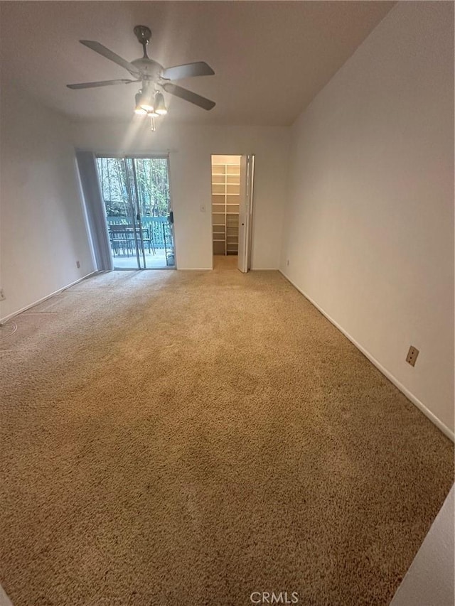 empty room with light carpet and a ceiling fan