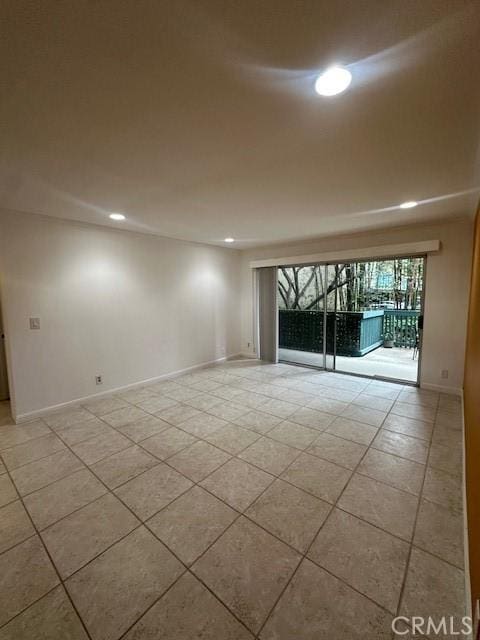 unfurnished room with recessed lighting and baseboards