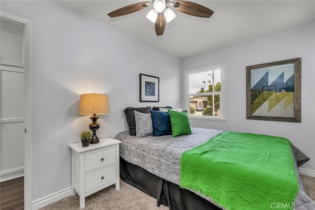 carpeted bedroom with baseboards and a ceiling fan