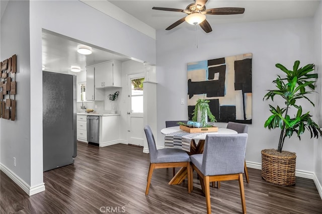 dining space featuring ceiling fan, baseboards, and dark wood-type flooring