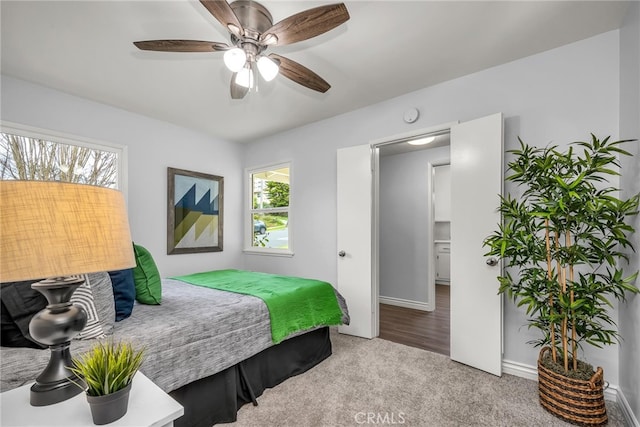 bedroom with ceiling fan, multiple windows, and carpet