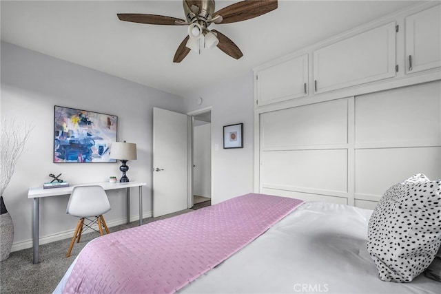 carpeted bedroom featuring a closet, ceiling fan, and baseboards