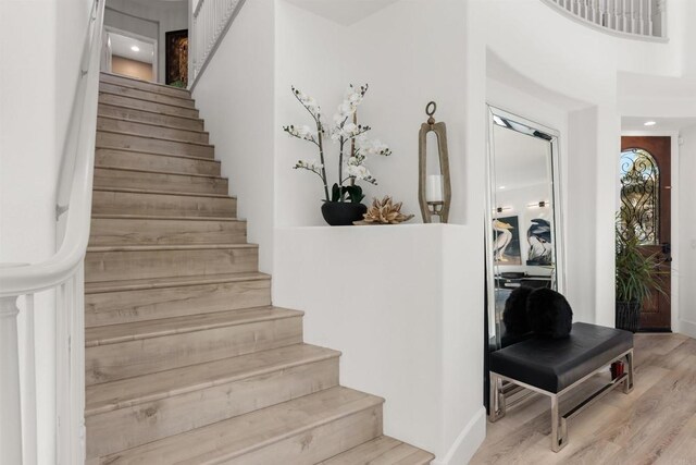 staircase with wood finished floors and visible vents