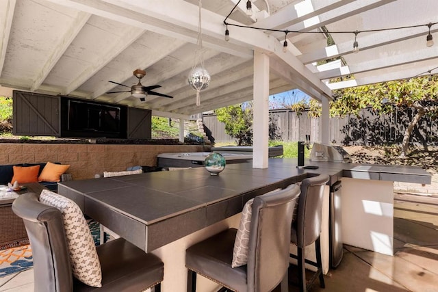 view of patio featuring outdoor dry bar, fence, area for grilling, a pergola, and a ceiling fan