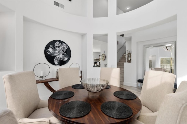 dining room featuring stairway, wood finished floors, and visible vents