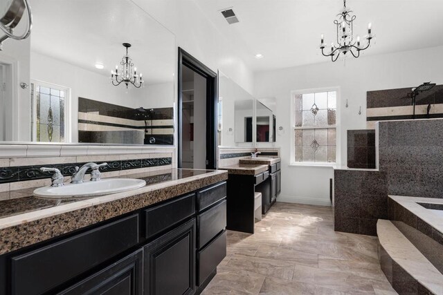 bathroom featuring a chandelier, visible vents, walk in shower, and a sink