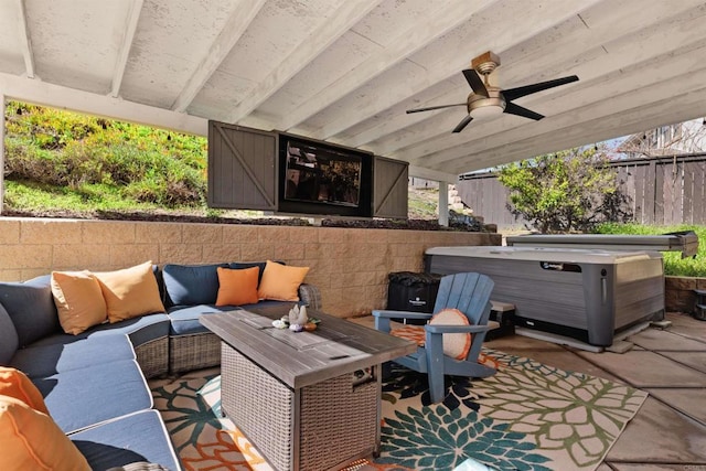 view of patio / terrace featuring an outdoor hangout area, fence, a ceiling fan, and a hot tub