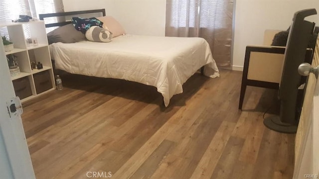 bedroom with wood finished floors