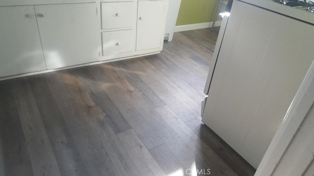 interior details featuring baseboards and wood finished floors