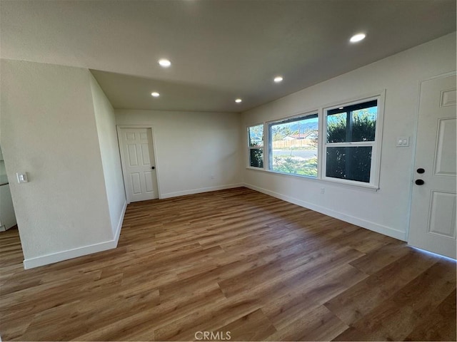 unfurnished room featuring recessed lighting, baseboards, and wood finished floors