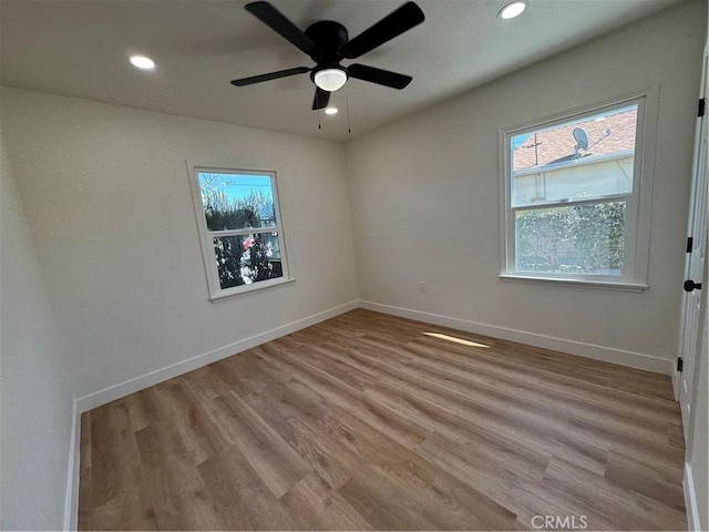 unfurnished room featuring recessed lighting, baseboards, wood finished floors, and a ceiling fan