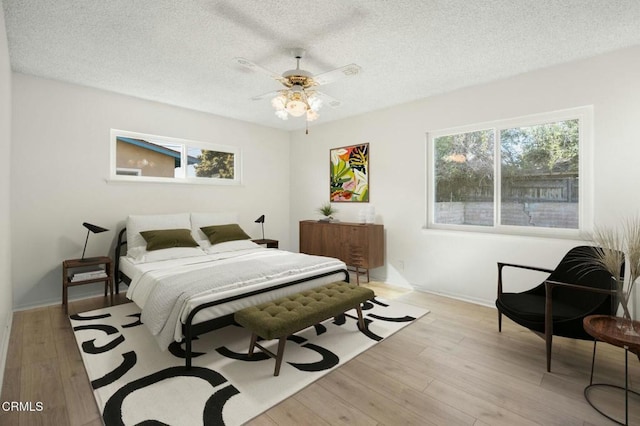 bedroom with a textured ceiling and light wood-style flooring