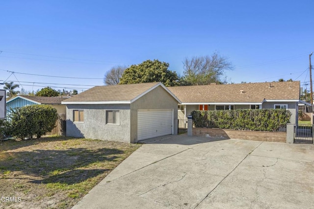 view of front facade featuring a gate, fence, and stucco siding