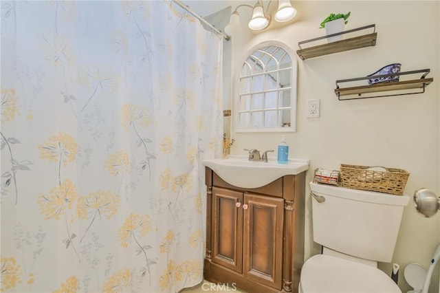 bathroom featuring toilet, a shower with curtain, and vanity