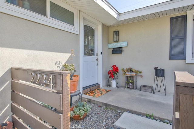 property entrance with stucco siding