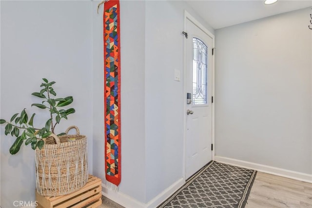 entrance foyer featuring baseboards and wood finished floors