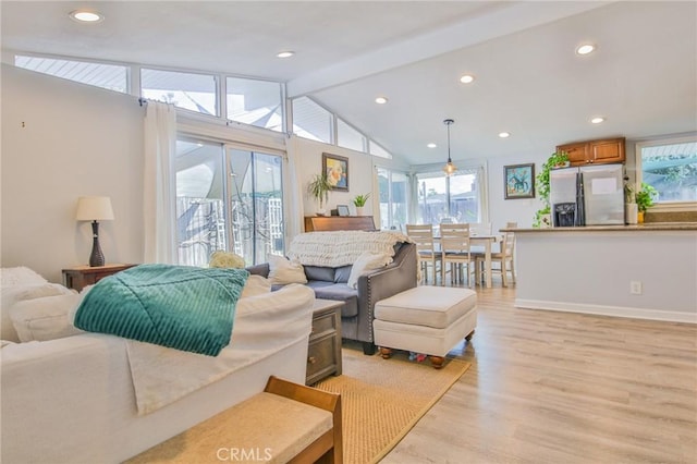 living area with lofted ceiling with beams, light wood-style floors, baseboards, and recessed lighting