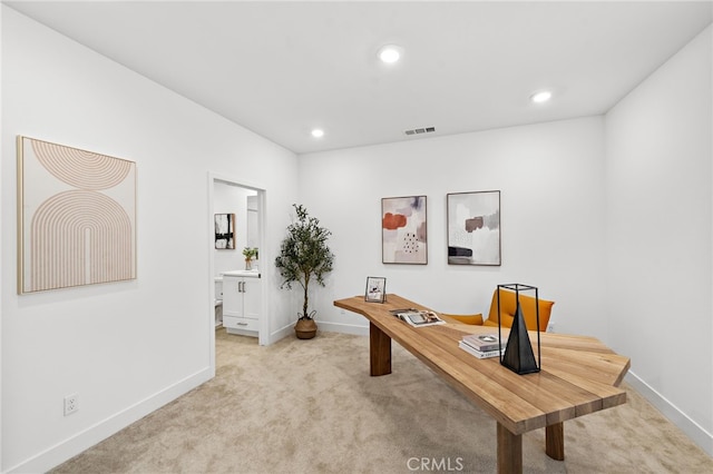 carpeted office space featuring recessed lighting, baseboards, and visible vents