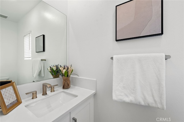 bathroom with vanity and visible vents