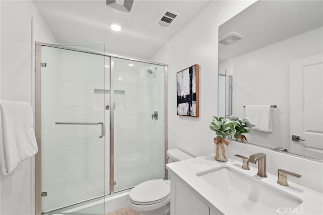 full bath with visible vents, vanity, toilet, and a shower stall