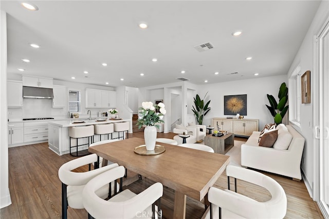 dining room with visible vents, recessed lighting, and wood finished floors