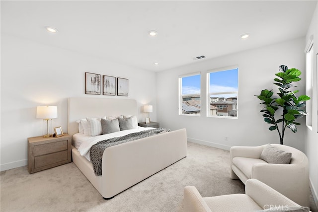 bedroom with recessed lighting, visible vents, light colored carpet, and baseboards