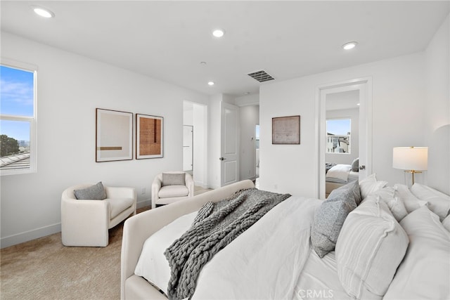 bedroom with recessed lighting, visible vents, light colored carpet, and baseboards