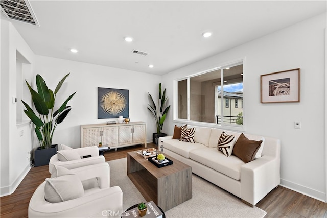 living room with visible vents, recessed lighting, baseboards, and wood finished floors